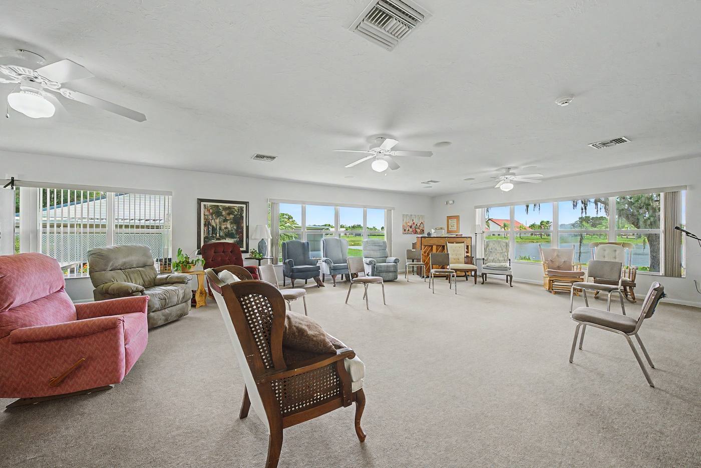 The Lodge common room with recliners and lake-facing windows