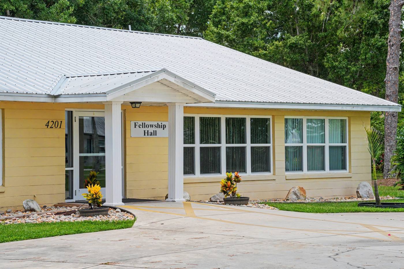 Fellowship Hall, a yellow building with a white metal roof