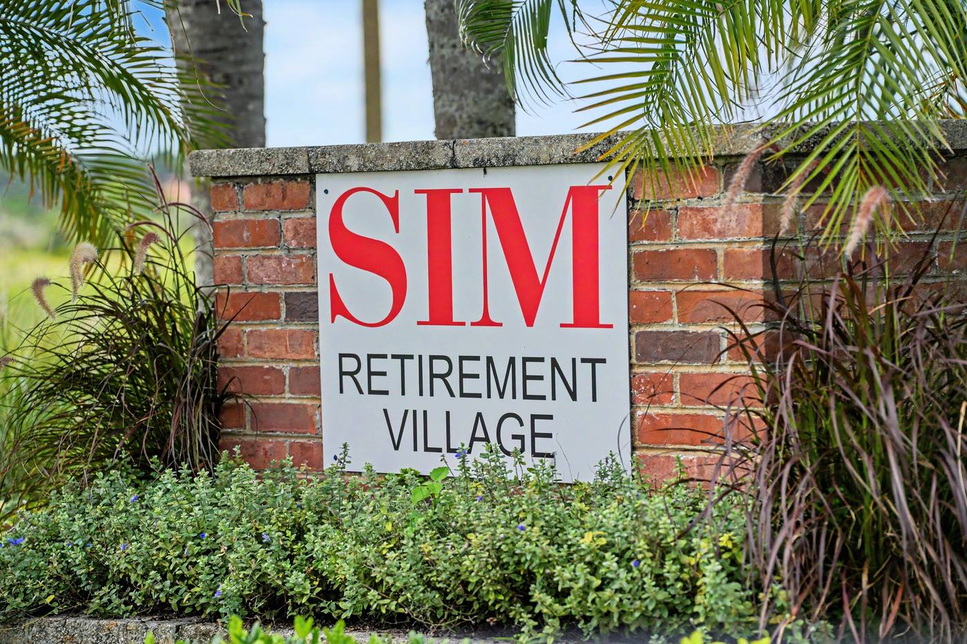 The brick entrance sign reading SIM Retirement Village