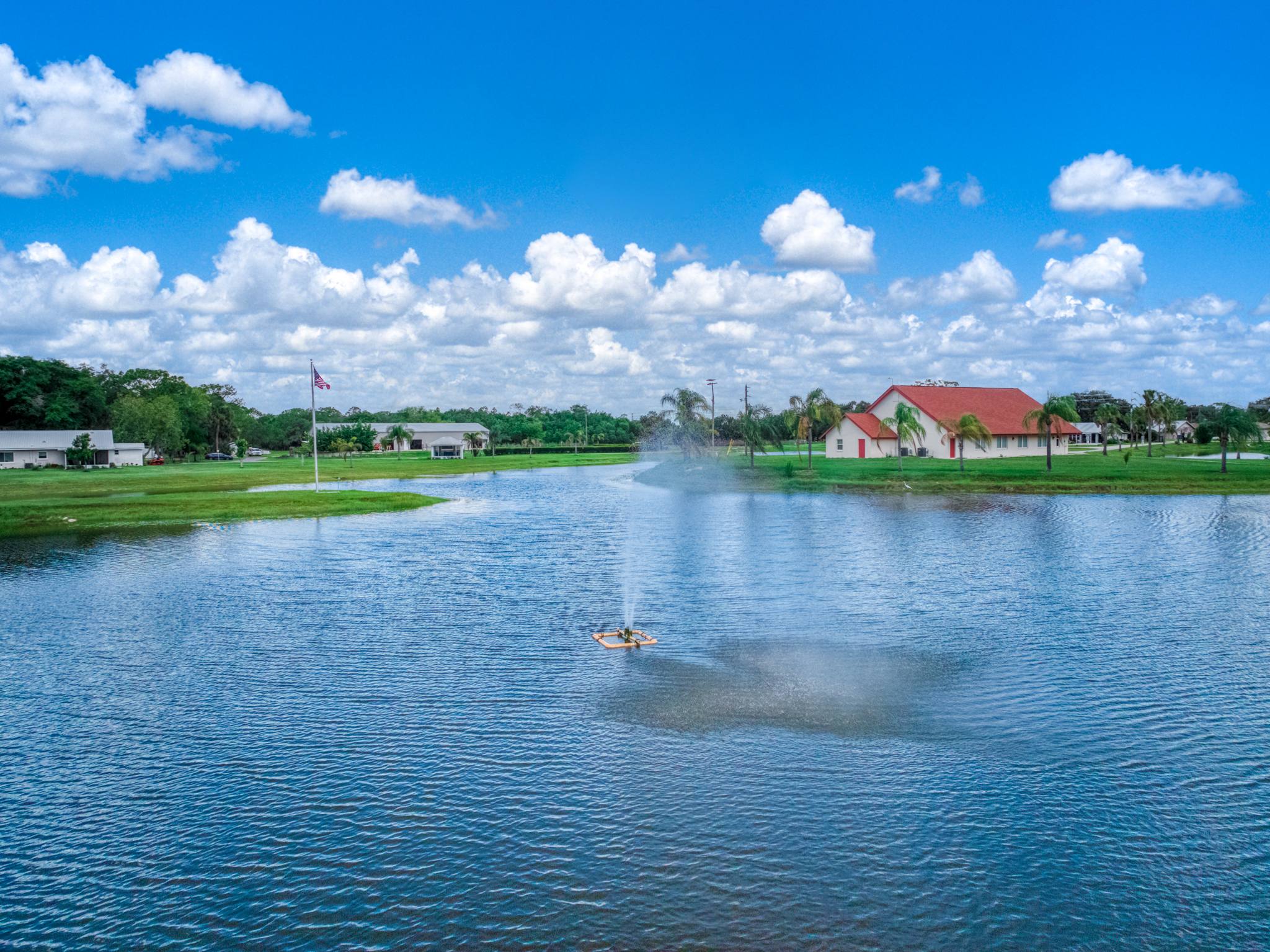 The lake with its fountain and the chapel in the distance under a big sky